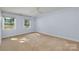 Spacious bedroom with neutral walls and carpet, featuring two large windows at 2400 Caswell Ct, Gastonia, NC 28054