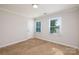 Well-lit bedroom with closet and carpet flooring at 2400 Caswell Ct, Gastonia, NC 28054