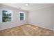 Spacious bedroom with two windows and carpet at 2400 Caswell Ct, Gastonia, NC 28054