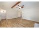 Open living room with hardwood floors, exposed beam, and access to kitchen at 2400 Caswell Ct, Gastonia, NC 28054