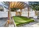 Cozy outdoor living space with a charming gazebo with artificial turf and natural stone accents at 3028 Semmes Ln, Indian Trail, NC 28079