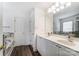 Bright bathroom with dual sinks, white cabinets, and a shower-tub combo at 3028 Semmes Ln, Indian Trail, NC 28079