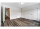 An empty bedroom featuring wood-look flooring, neutral paint, and a double-door closet at 3028 Semmes Ln, Indian Trail, NC 28079