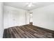 A bedroom showcasing wood-look floors and neutral paint with a double door closet at 3028 Semmes Ln, Indian Trail, NC 28079