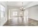 Bright dining room with hardwood floors and chandelier, open to kitchen at 3028 Semmes Ln, Indian Trail, NC 28079