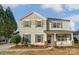 Two-story house with light beige siding, green shutters, and a landscaped front yard at 3028 Semmes Ln, Indian Trail, NC 28079