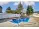 Backyard view of an in-ground pool with a large patio, fence, and shade trees at 3028 Semmes Ln, Indian Trail, NC 28079