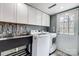 Updated laundry room with white cabinets and stainless steel sink at 3335 Knob Hill Ct, Charlotte, NC 28210