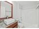 Clean bathroom with granite vanity, updated bathtub, and a modern sink at 3957 Picasso Ct, Charlotte, NC 28205