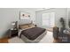 Virtually staged bedroom with modern decor and hardwood floors at 3957 Picasso Ct, Charlotte, NC 28205