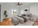 Virtually staged bedroom with hardwood floors and ceiling fan at 3957 Picasso Ct, Charlotte, NC 28205