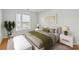 Virtually staged bedroom with green accents and hardwood floors at 3957 Picasso Ct, Charlotte, NC 28205