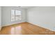 Bedroom with hardwood floors and large window at 3957 Picasso Ct, Charlotte, NC 28205