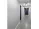 Long hallway with concrete floors and neutral colored walls at 3957 Picasso Ct, Charlotte, NC 28205