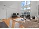 Living room with hardwood floors, large windows, and seating area at 3957 Picasso Ct, Charlotte, NC 28205