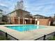 Community pool with brick building and surrounding fence at 3957 Picasso Ct, Charlotte, NC 28205