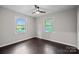 Bedroom with two windows and dark brown flooring at 401 Stokes Ave, Clover, SC 29710