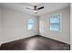 Bright bedroom with dark brown flooring and ceiling fan at 401 Stokes Ave, Clover, SC 29710