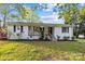 Charming ranch home with white brick exterior, covered porch, and landscaped yard at 401 Stokes Ave, Clover, SC 29710