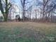 Wooded backyard with grassy area at 4830 Carnbrook Pl, Charlotte, NC 28212