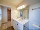 Clean bathroom with double vanity, and a mirrored medicine cabinet at 4830 Carnbrook Pl, Charlotte, NC 28212