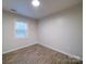 Simple bedroom with wood-look floors and a window at 4830 Carnbrook Pl, Charlotte, NC 28212