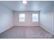 Well-lit bedroom featuring neutral walls and carpet flooring at 4830 Carnbrook Pl, Charlotte, NC 28212