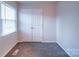 Simple bedroom with double door closet and window with blinds at 4830 Carnbrook Pl, Charlotte, NC 28212