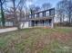 Two-story house with gray siding, white garage doors, and a covered porch at 4830 Carnbrook Pl, Charlotte, NC 28212