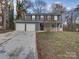 Gray sided two-story house with attached two-car garage and a front porch at 4830 Carnbrook Pl, Charlotte, NC 28212