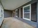 Covered front porch with white railing and gray siding at 4830 Carnbrook Pl, Charlotte, NC 28212