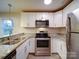 Kitchen with white cabinets, granite counters, and stainless steel appliances at 4830 Carnbrook Pl, Charlotte, NC 28212