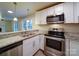 Kitchen with white cabinets, granite counters, and stainless steel appliances at 4830 Carnbrook Pl, Charlotte, NC 28212