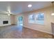 Living room with fireplace, wood-look floors, and sliding doors at 4830 Carnbrook Pl, Charlotte, NC 28212