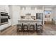 Modern kitchen with white cabinets and island with seating at 8616 Miles Gap Rd, Indian Land, SC 29707