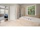 Bathroom with a shower, garden tub, and access to bedroom at 9243 Island Overlook Ct, Cornelius, NC 28031