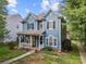 Two-story house with a landscaped yard and walkway at 9243 Island Overlook Ct, Cornelius, NC 28031