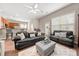 Relaxing living room with leather sofas and a view to the kitchen at 9243 Island Overlook Ct, Cornelius, NC 28031