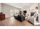 Spacious living room featuring hardwood floors, fireplace, and ample natural light at 9243 Island Overlook Ct, Cornelius, NC 28031