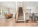 Elegant staircase with wood railings and carpet runner, connecting multiple levels at 9243 Island Overlook Ct, Cornelius, NC 28031