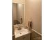 Simple bathroom with a sink, mirror, and tan tile at 9608 Sunway Dr, Mint Hill, NC 28227