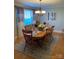 Elegant dining room featuring a wood table, chandelier, and large windows at 9608 Sunway Dr, Mint Hill, NC 28227