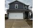 Two-story home with gray siding, stone accents, a two-car garage, and a well-maintained front yard at 102 Alden Ct, Shelby, NC 28152