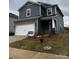 Two-story home with gray siding, stone accents, two-car garage, and small front yard with 'available' sign at 102 Alden Ct, Shelby, NC 28152