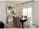 Formal dining room featuring a black wood table, wicker chairs, and abstract art at 1103 Harry Ct, Albemarle, NC 28001