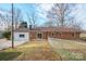 Backyard features a well-maintained lawn and a brick house with a sliding glass door at 1254 Huckleberry Dr, Lincolnton, NC 28092