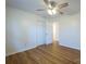 This bedroom includes light hardwood floors, ceiling fan with light fixture, and closet at 1254 Huckleberry Dr, Lincolnton, NC 28092