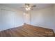 Bright bedroom features modern ceiling fan, wood-look flooring, and closet with paneled doors at 1254 Huckleberry Dr, Lincolnton, NC 28092
