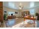 This virtually staged living room includes natural paint, windows, and desk/bookshelf furniture at 1254 Huckleberry Dr, Lincolnton, NC 28092