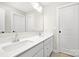 Double vanity bathroom with a large mirror and white cabinets at 13026 Arnold Palmer Cir # 1051, Lancaster, SC 29720